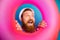 Close up photo excited surprised shocked bearded man hold round float saver look ahead scream wow omg wear white