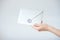 Close-up photo of female hands with wax seal with invitation envelope, gift certificate, postcard, wedding invitation card