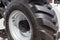 Close up photo of fragment huge tire wheel of construction or agriculture automobile equipment