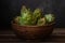 Close up photo of fresh artichoke in the old wooden bowl on dark background