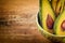 Close-up photo of fresh sliced avocados, brown seeds visible in green bowl