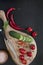 Close-up photo of fresh vegetables on wooden cutting board with knife on black concreted table background. Top view