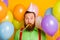 Close up photo of funky funny carefree man blow party whistle have air helium balls baloons wear good look clothes over