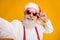 Close up photo of funky positive grandfather modern blogger in santa claus hat enjoy fairy newyear x-mas eve celebration