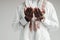 Close up photo. Hands of arab man in white shirt folded together while praying in mosque