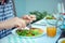 Close up photo of hands man eating salad, quinoa and fish on terrace