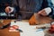 Close-up photo the hands of a skilled shoemaker make a bag from a piece of genuine leather