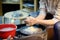 Close-up photo of hands of woman making clay object