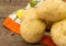 Close up photo of heap of potatoes on cloth with wood