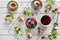 Close-up photo of homemade cakes with mascarpone cheese, cinnamon, strawberries, blueberries and beautiful wild apple tree floweri