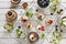 Close-up photo of homemade cakes with mascarpone cheese, cinnamon, strawberries, blueberries and beautiful wild apple tree floweri