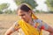 Close-up photo of An indian young farmer lady stood up wearing a yellow Rajasthani veil as per the custaom