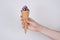 Close up photo of lady`s hand getting giving taking tasty ice cream with chocolate on top isolated grey background with copy spac