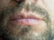 Close-up photo of the lower part of the male face lips and beard