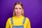 Close up photo of mad person grimacing wearing yellow turtleneck denim jeans overalls isolated over violet purple