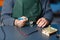 Close-up photo of male engineer or technician repair soldering drone details.