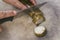 Close up photo of a man cutting traditional malay food during Aidilfitri