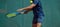 Close up photo of a man swinging a tennis racquet during a tennis match