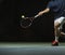 Close up photo of a man swinging a tennis racquet during a tennis match