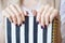 Close-up photo of manicured woman`s hands hold an elegant notebook with black and white strips