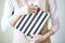 Close-up photo of manicured woman`s hands hold an elegant notebook with black and white strips