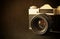 Close up photo of old camera lens over wooden table. image is retro filtered. selective focus.