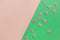 Close up photo of pink butterflies glitter confetti on colorful pink and green background. Top view, spring, Easter and various