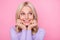 Close-up photo portrait of smiling curious cheerful old lady looking at empty space isolated on pastel pink color