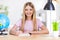 Close up photo of positive kid girl study remote write pencil copy book enjoy homeschooling sit table desk in house