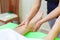 Close up photo of professional therapist hands giving relaxing reflexology Thai oil leg massage treatment to a woman in