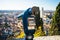 A close up photo of a public monocular on the top of a mountain with spectacular aerial views of the old city of Verona in Italy.