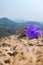 A close up photo of purple Purple Ruellia Tuberosa with blurry mountain background