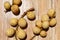 close up photo of ripe duku fruit with a wooden background.