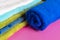 Close up photo of rolled stack of colorful towels b