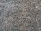 Close up photo of rough asphalt. Dark gray detailed texture