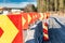 Close up photo at row of warning direction drive signs, temporarily placed at corner of road under construction to avoid collision