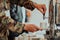 Close-up photo of soldier serving themselves in a modern hotel during a dinner party. Selective focus