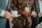 Close-up photo of soldier serving themselves in a modern hotel during a dinner party. Selective focus