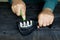 Close up photo of someone`s hand sharpening a kitchen knife using a sharpener