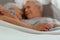 Close-up photo of spouses lying in the bed and hugging