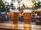 Close up photo of tall glasses with light lager craft beer pint standing on bar wooden table deck with amusement park in