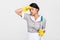 Close-up photo of tired brunette girl in uniform holding mop and