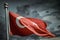 Close-up photo of Turkey flag waving in the wind in front of dramatic sky