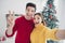 Close up photo of two cheerful romantic spouses people take selfie blogs make v-signs show christmas celebration