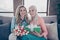 Close up photo two people she her ladies child grandmother grandchildren visit birthday party deliver mommy giftbox