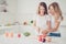 Close up photo of two people mum and teen daughter holding knife cooking lesson mom knows best wear white t-shirts denim