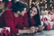 Close up photo of two romantic married people use cell phone feel romance lying on floor with gift boxes have christmas