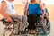 Close up photo of wheelchairs and handicapped war veterans playing basketball on the court