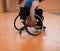 Close up photo of wheelchairs and handicapped war veterans playing basketball on the court