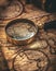 A close-up photograph of a classic magnifying glass hovering over the intricate details of an antique map